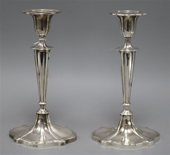 A pair of George V silver candlesticks by Walker & Hall, Sheffield, 1919, 24cm.